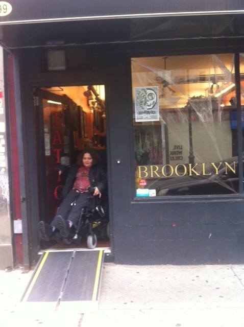 woman in wheelchair exiting a store